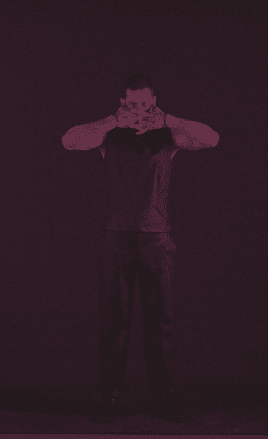 Editorial portrait of a male model covering his face