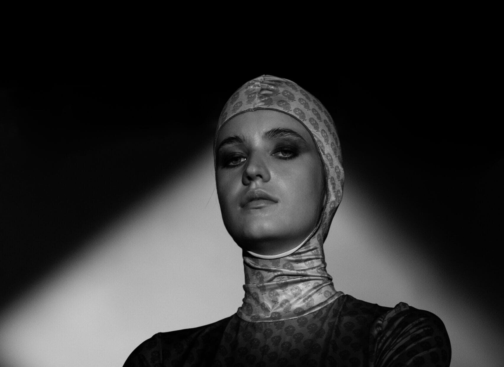 Dramatic black and white editorial portrait with hard spotlighting by Extenso Studio in Vancouver.