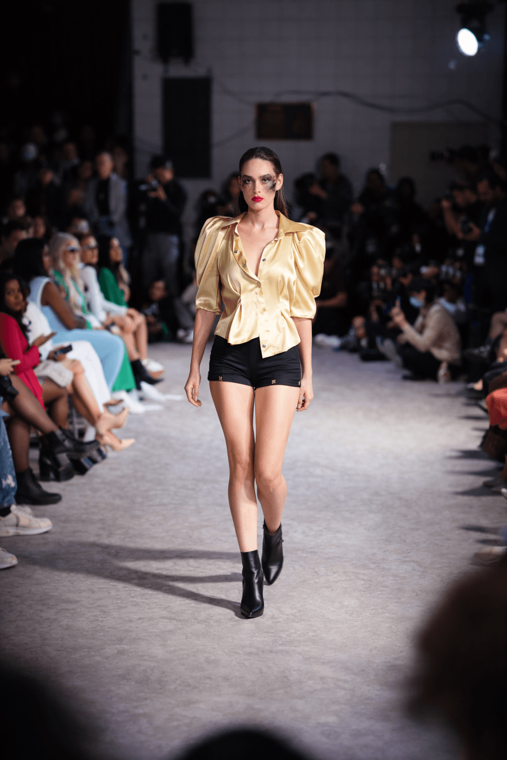 Shimmering gold blouse and black shorts