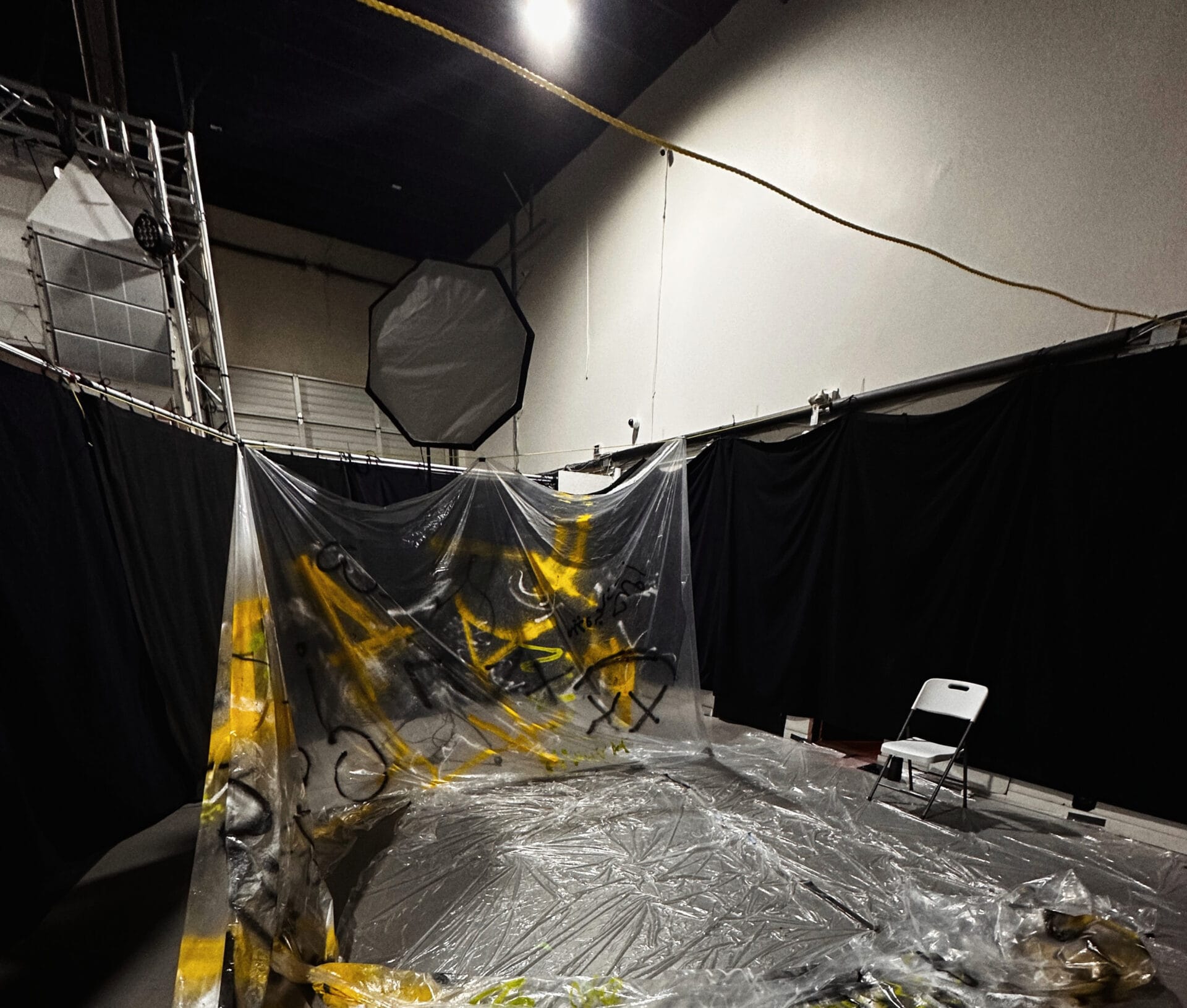 Custom studio set with spray-painted clear plastic sheeting and lighting setup for a commercial photoshoot at Extenso Studio.