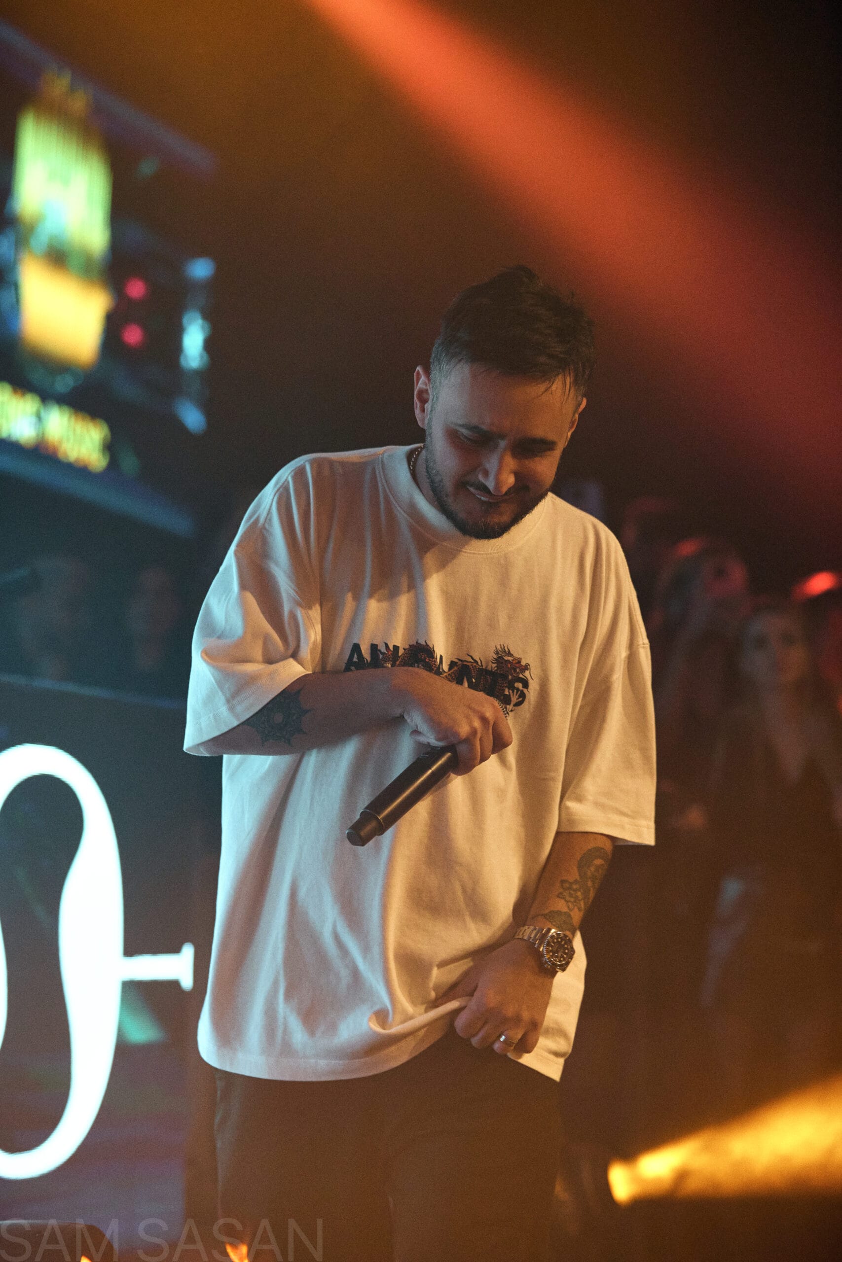 Artist performing bathed in colorful stage light