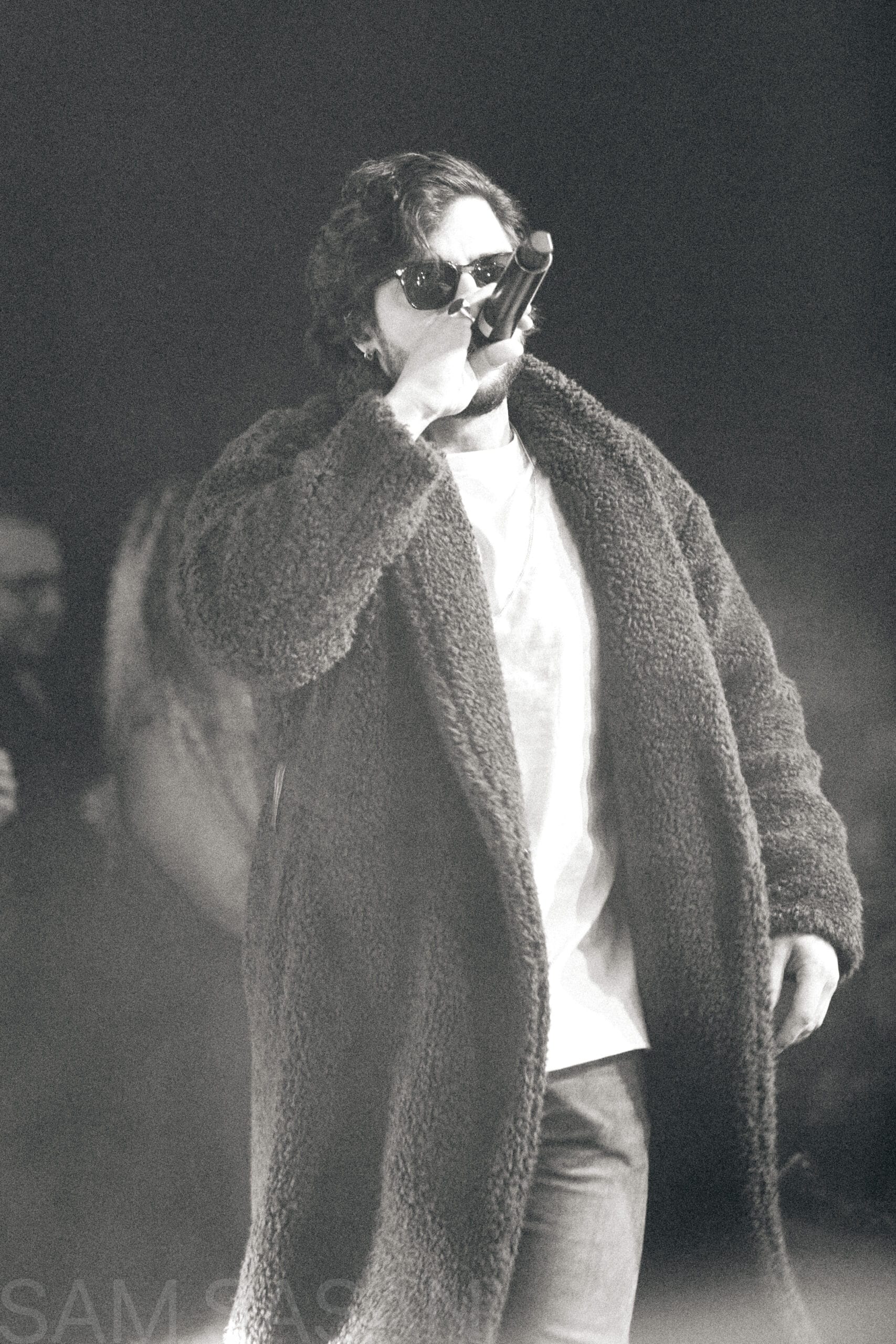 Black and white portrait of an artist singing passionately