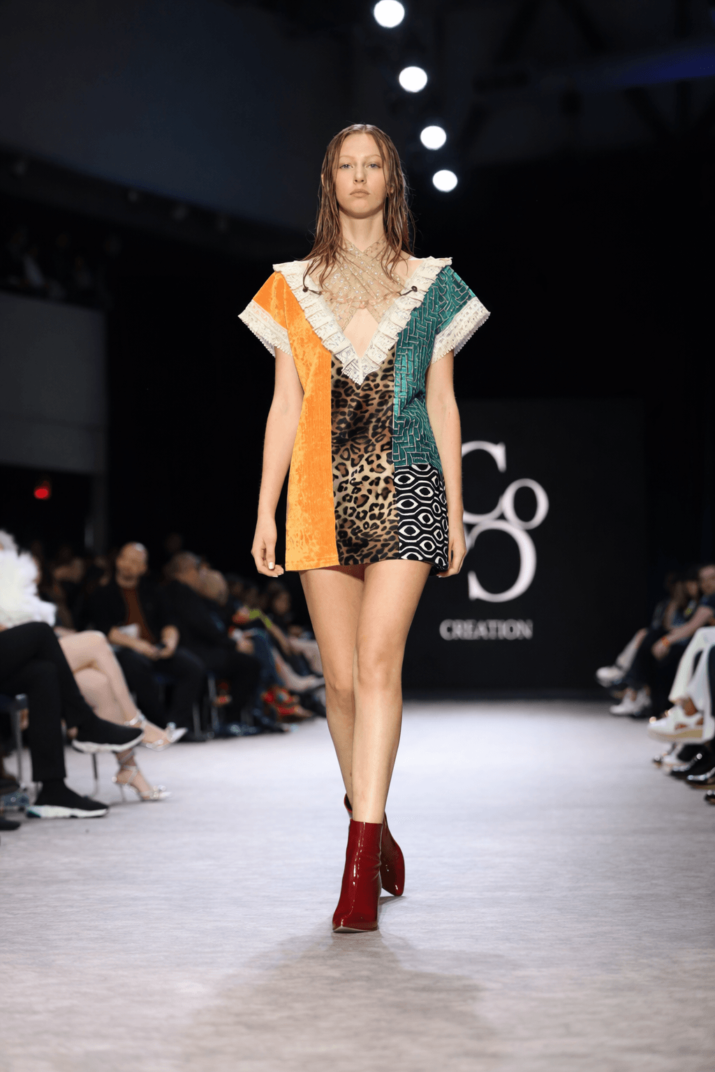 Fashion model wearing a vibrant color-blocked velvet mini dress